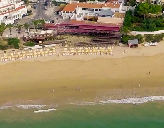 <p>Oura Beach is the main beach in the centre of Albufeira New town and serves the area closest to the strip in Areias do Sao Joao. If you're on a stag, hen or group weekend it is likely this will be your go-to beach and it will not disappoint, the beach itself is almost half a kilometre long and covered in perfect smooth fine sand along with the beach bed hire one of our partners provides all the beach watersports you could ever wish including jet ski hire, banana boat rides, waterskiing, parasailing and even the incredible flyboarding experience.</p>
<p>Now if watersports aren't your thing don't worry Oura beach or Praia da Oura in Portuguese, have all the other bases covered, where the town meets the beach you will find a long line of beach bars, restaurants, shops and cafes where you can sip cocktails, down a few pints and catch a football match on a widescreen tv all within touching distance of the sun, sea and sand.</p>
<p>If you're on more of a sedate trip to Albufeira the beach is actually split in two by a large rocky outcrop that makes our coastline famous throughout the world, when the tide is low, you can check the <a href="https://www.tide-forecast.com/locations/Albufeira/tides/latest" target="_blank" rel="noopener">Albufeira tides</a> here, you can walk around the rocks and there you will find Oura Beach East or Praia da Oura Leste. The eastern section of the beach is again almost 500 metres long and is dotted with beach bars and sunbeds and makes for a perfect early morning or sunset walk</p>