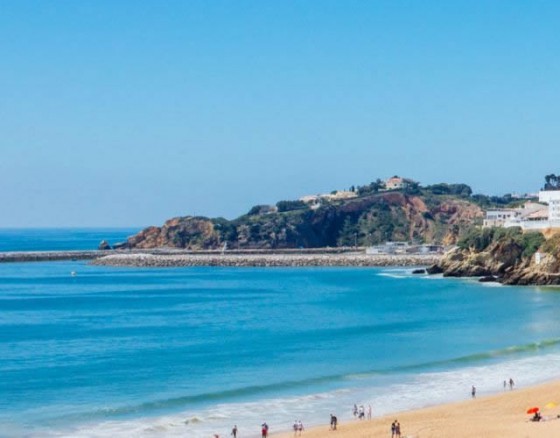 <h6>Fisherman's Beach Albufeira: The Heart of Albufeira's Coastline</h6>
<p>Located at the foot of Albufeira's old town, Fisherman&rsquo;s Beach (Praia dos Pescadores) is one of the most iconic and vibrant beaches in the Algarve. With its stunning golden sands, crystal-clear waters, and historic surroundings, this beach offers a perfect blend of relaxation and excitement, making it a must-visit for clients of Portugal Rocks.</p>
<h6>Scenic Beauty and Relaxing Vibes</h6>
<p>Fisherman&rsquo;s Beach is known for its picturesque beauty. Framed by the towering cliffs and nestled between the charming streets of Albufeira, it&rsquo;s the ideal spot to unwind while enjoying the warmth of the Algarve sun. The beach is just a stone's throw away from the town&rsquo;s lively centre, making it easy to spend a relaxing day here without venturing far from the action. The beach is also sheltered from strong winds, making it perfect for sunbathers and swimmers alike.</p>
<h6>Watersports and Adventure</h6>
<p>Fisherman&rsquo;s Beach is a hotspot for a variety of watersports, offering everything from jet skiing and parasailing to paddleboarding and kayaking. With the calm waters and ample space, it's perfect for both beginners and seasoned adventurers. For those looking for a more active beach experience, the opportunity to rent equipment or join in on guided activities is readily available. Whether you're looking to zip across the water or try something new, the beach provides the perfect playground for all kinds of water lovers.</p>
<h6>Local Culture and Dining</h6>
<p>One of the most distinctive features of Fisherman&rsquo;s Beach is its proximity to Albufeira&rsquo;s rich history. As you relax on the sand, take in the sights and sounds of the old town, with its narrow cobblestone streets, whitewashed buildings, and colourful shops. The beach is also home to a number of traditional Portuguese restaurants where you can savour fresh seafood. The atmosphere is casual yet inviting, with many places offering outdoor seating so you can enjoy a meal while taking in the stunning coastal views.</p>
<h6>Nightlife and Evening Entertainment</h6>
<p>When the sun sets, Fisherman&rsquo;s Beach transforms into a lively spot where you can enjoy a variety of bars, pubs, and restaurants. The area comes alive with music, outdoor seating, and spectacular views of the ocean at dusk. Clients of Portugal Rocks looking for a fun evening can easily transition from beach relaxation to Albufeira&rsquo;s buzzing nightlife scene, with plenty of bars and clubs nearby to keep the party going well into the night. Whether you&rsquo;re sipping cocktails by the sea or dancing the night away, there&rsquo;s no shortage of excitement at Fisherman&rsquo;s Beach.</p>
<h6>A Perfect Destination&nbsp;</h6>
<p>Fisherman&rsquo;s Beach is the ultimate destination for anyone looking to experience the best of Albufeira. With its stunning setting, wide range of activities, and vibrant atmosphere, it's perfect for stags, hens, and groups of friends. Whether you're in the mood for relaxation, adventure, or enjoying the local culture, Fisherman&rsquo;s Beach offers something for everyone, making it a must-visit location.</p>