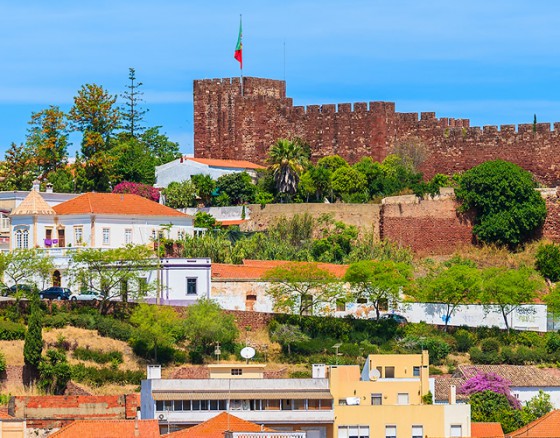 <p>Silves is an enchanting town littered with orange and lemon trees, sitting on the banks of the Arade River (Rio Arade). There is history everywhere you look in Silves, to remind you of its affluent and bold past as a Moorish capital (“Xelb”). The most prominent monument is Castelo de Silves, which is now the best preserved castle in the Algarve. The castle and the Cathedral beside it are the first buildings you see as you approach Silves, as they sit on the hilltop above the town. Sé de Silves (Cathedral of Silves) one of the Algarve’s few remaining gothic monuments with ancient tombs, sits alongside the castle and a network of narrow, cobbled streets take you down into the town. </p>
<p>Silves has a very pretty central square, Praça do Municipio, with palms and flowers, beautiful gardens, and a newly paved river front which leads you to the swimming pool and beyond. If you would like to improve your fitness a little there is an exercise area near the pool with Life Trail Wellness Stations an outdoor play area for adults. What a great idea, especially in the fabulous climate of the Algarve.</p>