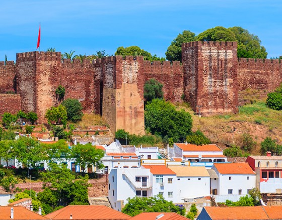 <p>Silves is an enchanting town littered with orange and lemon trees, sitting on the banks of the Arade River (Rio Arade). There is history everywhere you look in Silves, to remind you of its affluent and bold past as a Moorish capital (“Xelb”). The most prominent monument is Castelo de Silves, which is now the best preserved castle in the Algarve. The castle and the Cathedral beside it are the first buildings you see as you approach Silves, as they sit on the hilltop above the town. Sé de Silves (Cathedral of Silves) one of the Algarve’s few remaining gothic monuments with ancient tombs, sits alongside the castle and a network of narrow, cobbled streets take you down into the town. </p>
<p>Silves has a very pretty central square, Praça do Municipio, with palms and flowers, beautiful gardens, and a newly paved river front which leads you to the swimming pool and beyond. If you would like to improve your fitness a little there is an exercise area near the pool with Life Trail Wellness Stations an outdoor play area for adults. What a great idea, especially in the fabulous climate of the Algarve.</p>