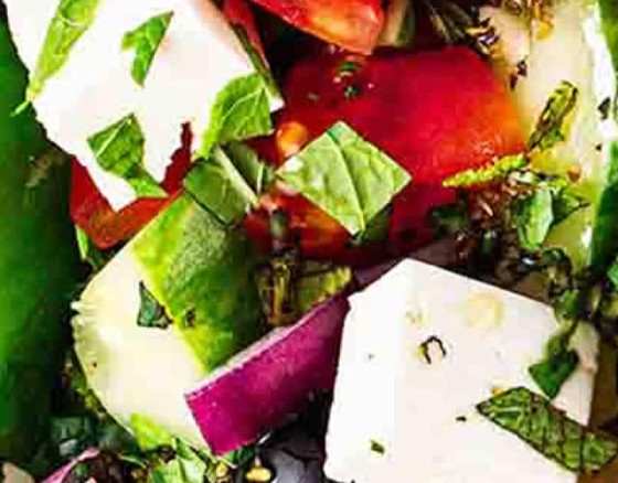 Fresh mixed salad leaves and pasta served with sliced red onion, tomatoes, olives and feta cheese served with a balsamic glaze and oregano.